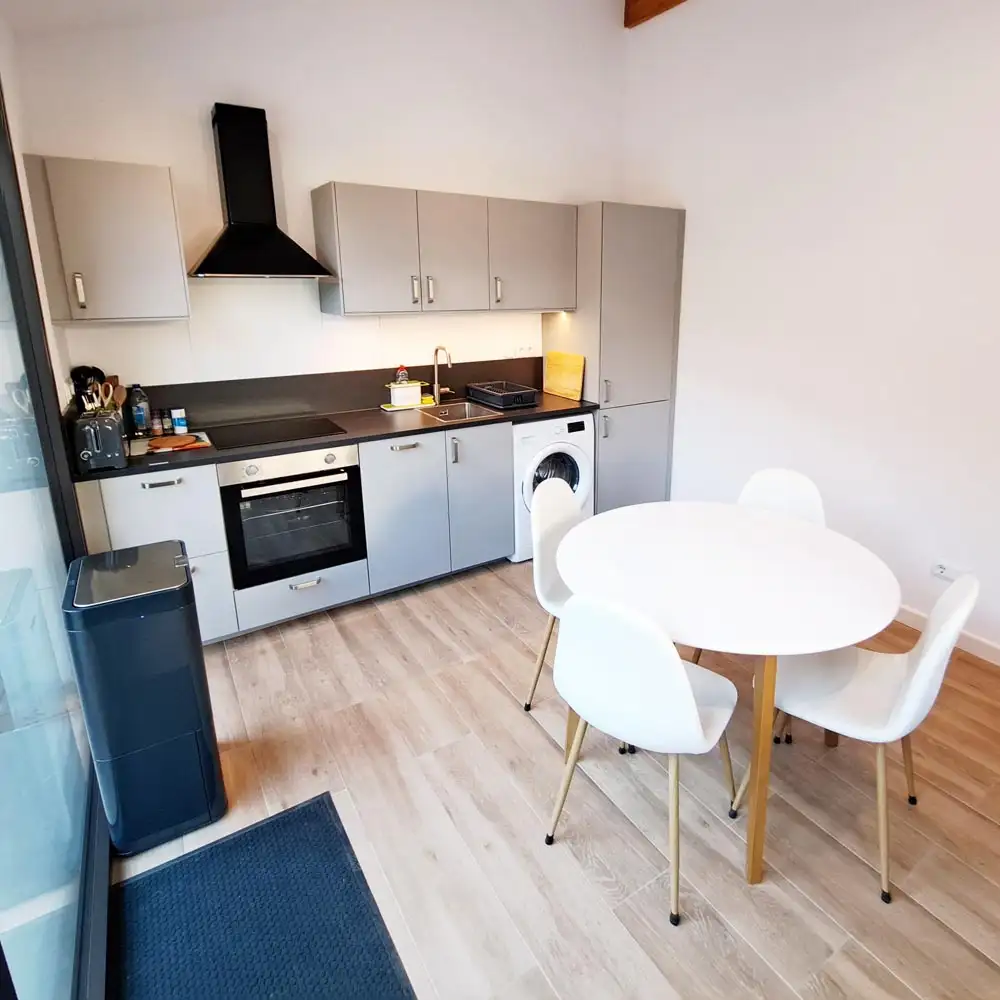 Kitchen With Washing Machine Washing machine and fold-away clothes drying rack in the open plan kitchen.